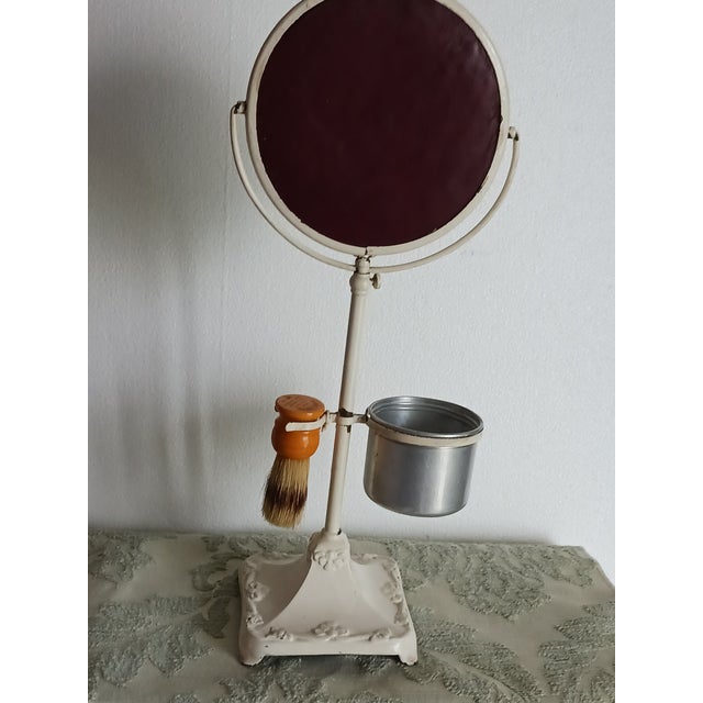 1920's shaving stand of cast iron with cup, bakelite brush, and beveled glass swing mirror. Just like the Arrow man might...