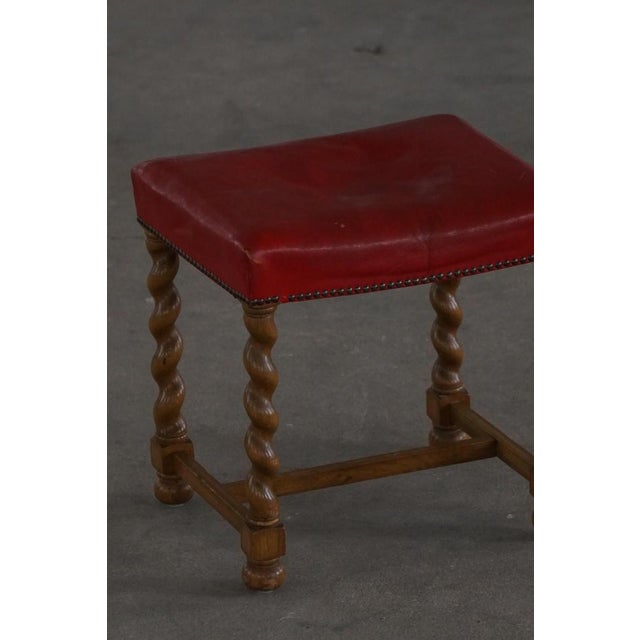 An exquisite early 20th‑century Danish oak stool, beautifully crafted with barley twist turnings and a richly upholstered...