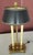A Stiffel sryle brass double bouillotte table lamp featuring a dark green shade Style: Regency/French Empire, featuring a...