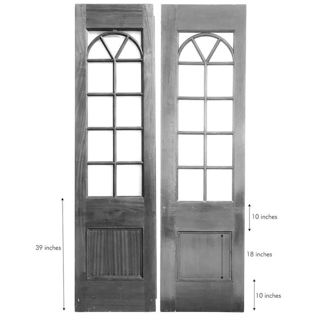 DETAILS This pair of vintage custom made doors was fashioned with beveled panes with an arched top in a solid mahogany...