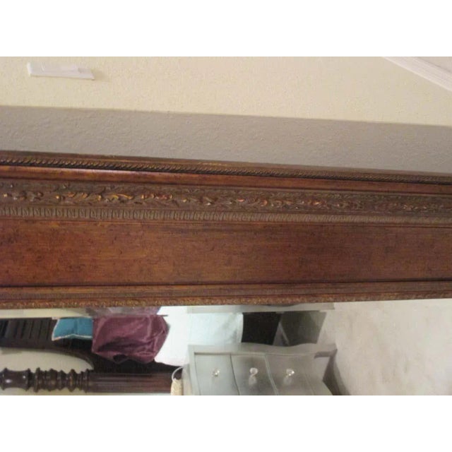 Large ornate gilded floor mirror that measures 67.5” x 91.5” x 3.25.”. Beveled edges.