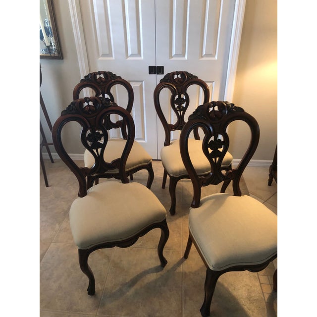Four Balloon Back Parlor Chairs, Pear or Rosewood carved frame with fancy fruit and rosettes. Upholstered in taupe linen...