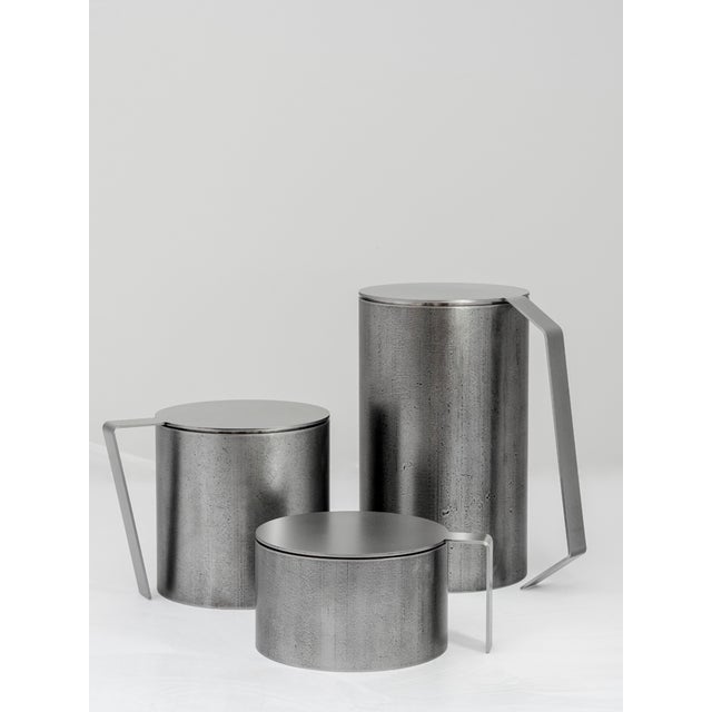 Three sculptural containers highlight the ability of metal and its craftsmanship to adapt to emotional, perceptive, and...