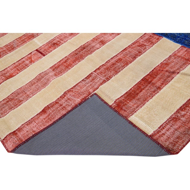 The classic Stars and Stripes design of the United States flag is recreated here by stitching together. This beautiful...