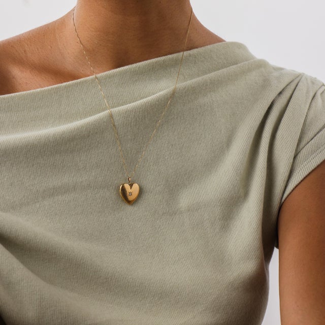 This charming vintage diamond heart locket pendant necklace is a romantic 1970’s piece, crafted in warm 14k yellow gold....