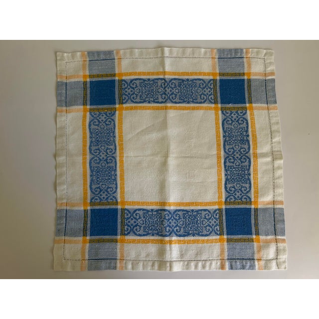 Set of six mid-20th century l woven linen napkins, executed in a blue and mustard plaid with integrated jacquard damask...