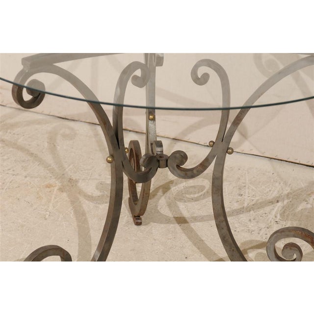 A Round Center, Side or Dining Table with Glass Top and Nice Scrolled Tripod Steel Base.