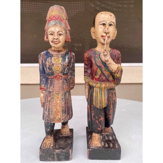 These are hand-carved Asian wooden statue figurines, representing a traditional couple or figures from folklore painted...