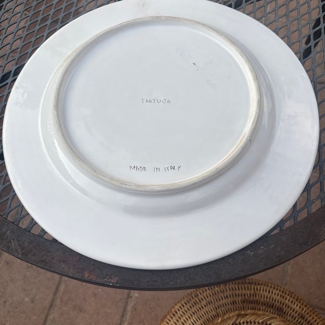 This hand-painted Italian ceramic dinner plate features the "Tartuca" (Tortoise) emblem from the historic Palio di Siena...