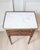 Elegant Louis XVI–style side table crafted in mahogany during the 20th century, reflecting the refined neoclassical...