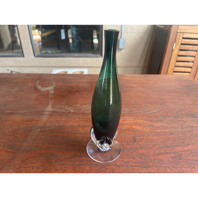 Circa 1950 this blown decanter has very simple modern lines including a free-formed "3 leaf stem" applied foot. The sleek...