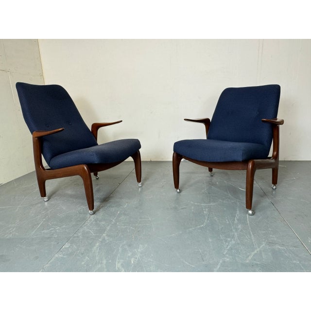 Set of 2 Danish style mid century modernist teak lounge chairs, 1960s One chair is 90 cm high and the other 80 cm. A Lady...