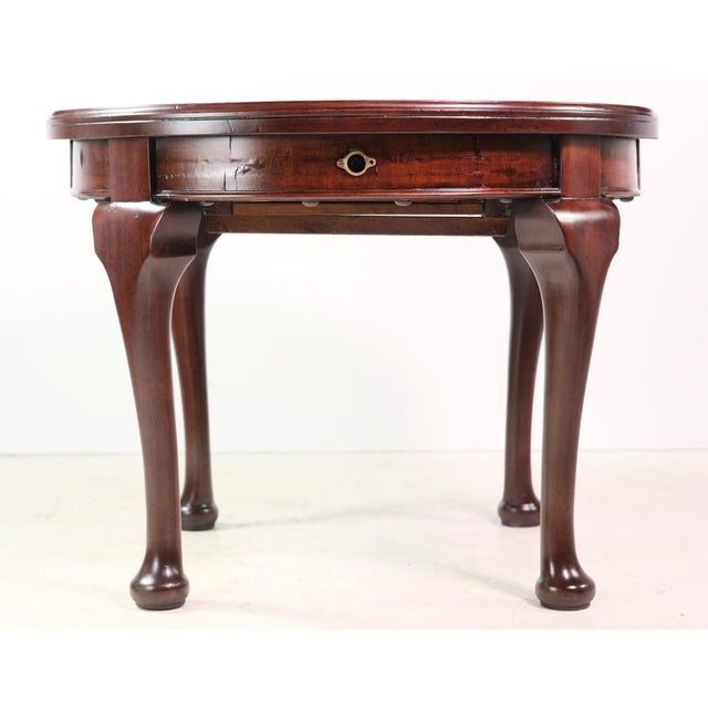Vintage Queen Anne style mahogany wood side table with cabriole legs. There is a winding key socket on the side of the...