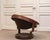 Its sculptural circular form is one of the model’s most distinctive features. A curved wooden frame surrounds the deep...