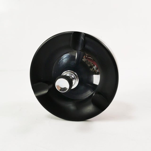 Table ashtray from Belgium, 1940s. It features an Art Deco design, made of metal and Bakelite, features a rotating...