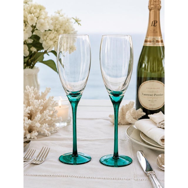 Elevate your next celebration with this elegant pair of vintage tall champagne flutes by the Libbey Glass Company....