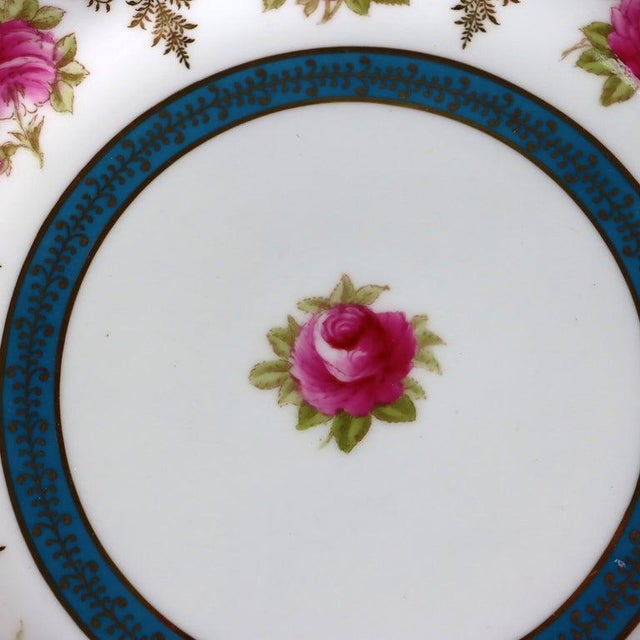 A distinguished set of twelve antique English porcelain luncheon plates, crafted by Cauldon and retailed by the esteemed...