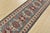 A tribal Caucasian Kazak runner hand-knotted with fine wool on a cotton foundation. This rug features a row of geometric...