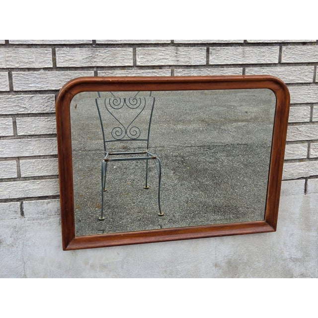 The 1920 walnut rectangular wall beveled edge mirror is a stylish and elegant addition to any room. With a sleek brown...