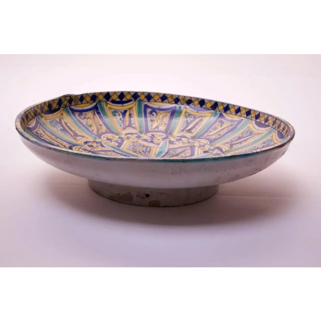 Large-scale terracotta charger (circa 1940s, Italy) with bright blue, teal, and yellow geometric patterns with ornamental...