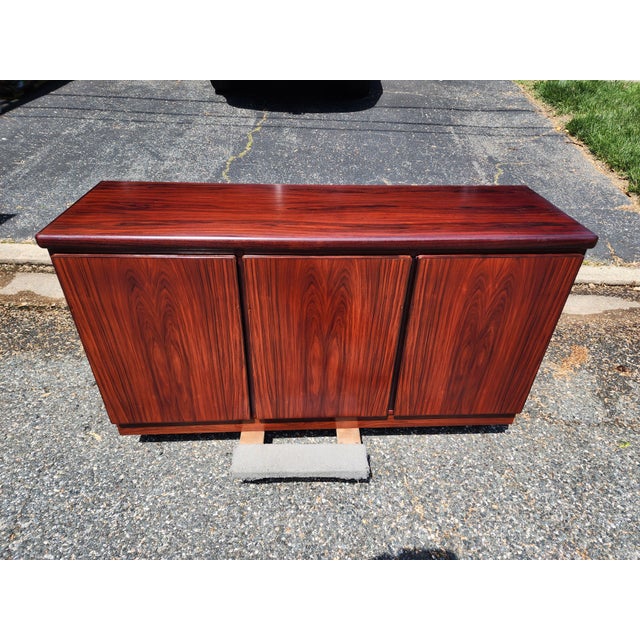 Elevate your space with this stunning vintage Skovby mid-century modern credenza, crafted in rich rosewood with timeless...