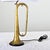 A vintage Couesnon brass trumpet made in France that has been upcycled into a one-of-a-kind table lamp. The horn shows...