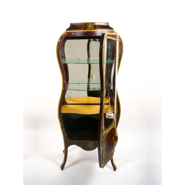 Elevate your living space with this Antique Louis XV Style Bronze-Mounted Curio Vitrine Cabinet, a piece of furniture that...