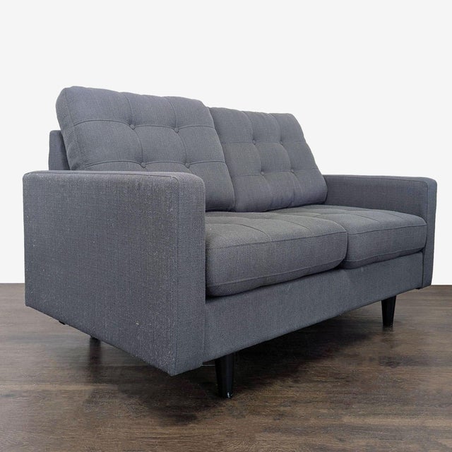 This stylish dark gray loveseat features soft fabric upholstery and comfortable, tufted cushions. Its compact size and...