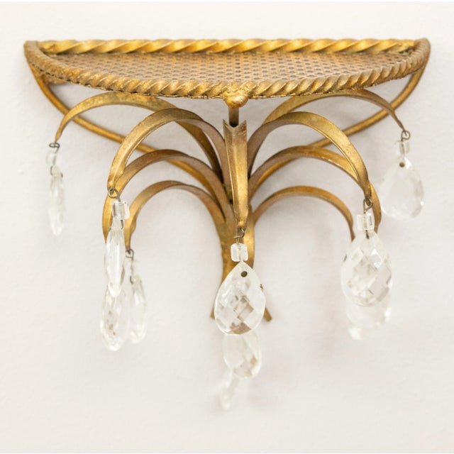 A gorgeous pair of vintage Mid-20th Century Hollywood Regency style Italian gilt tole and crystals wall brackets shelves....