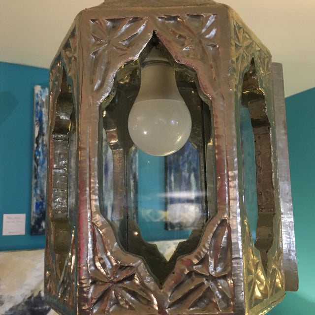 Amazing hanging light fixture made of hammered German silver over wood with glass windows. One window opens to reach the...