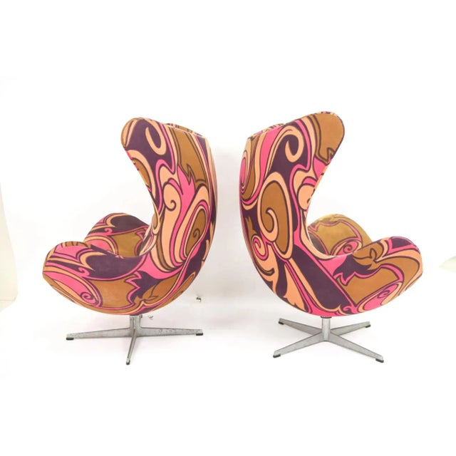 A rare and exceptional pair of Arne Jacobsen for Fritz Hansen Egg chairs and matching ottoman. The set h having its...