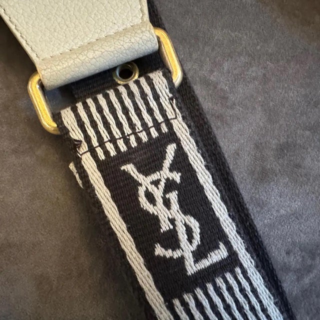 This authentic Yves Saint Laurent pouch embodies the sleek, pared-down aesthetic of 1990s luxury with its clever blend of...