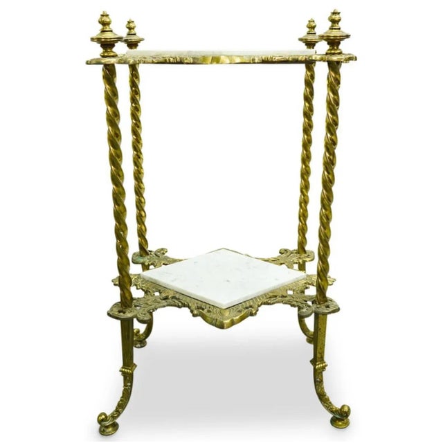 Vintage heavy brass and marble two tier small side table designed with a solid brass frame with twisted legs, and marble...