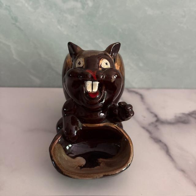 Interesting mid-20th century nut dish in the shape of a squirrel. Made of painted ceramic with drip glaze and gold edging....