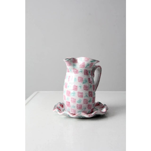 This is a vintage studio pottery ewer and plate set. Signed by the artist, the hand-crafted white ceramic pitcher and...