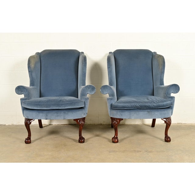 A gorgeous pair of Chippendale or Georgian style wingback library chairs, lounge chairs, or fireside chairs By Kindel...