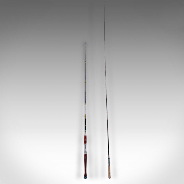 This is a vintage cased fishing rod set. A Japanese, bamboo rod duo within a pine carry case, dating to the mid 20th...