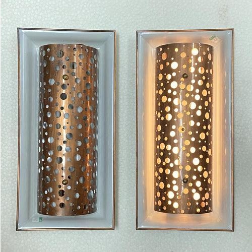 Large pair of 1950s custom made metal wall lights with curved copper diffusers decorated with random oversized...