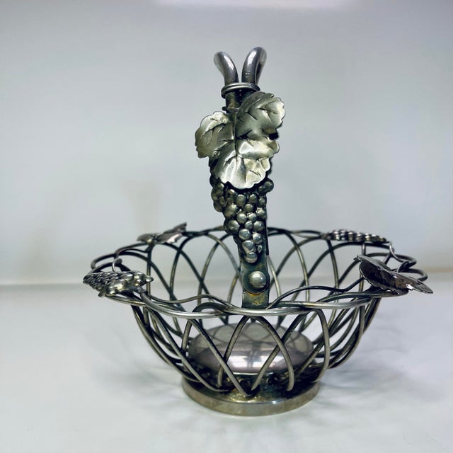 A charming vineyard themed silver plate metalwork basket decorated with grapes & leaves.