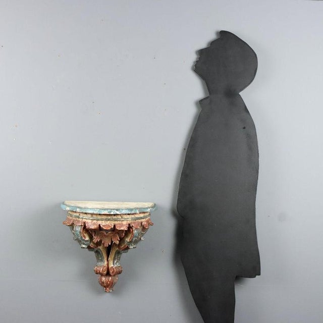 Small drop leaf console in carved wood showcasing the elegance of 18th-century Italian craftsmanship. The structure...