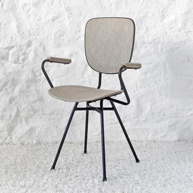 Tubular structure in black lacquered metal, seat, backrest and armrests upholstered in rough plaster in ecru and gray...