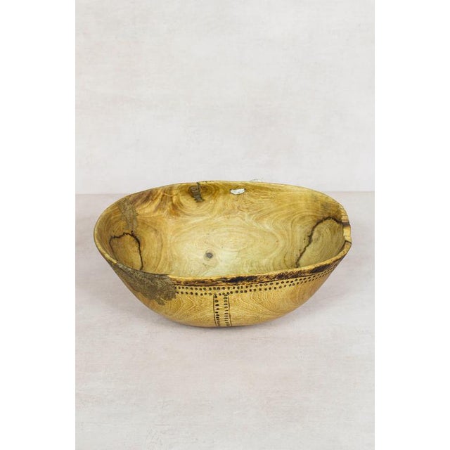 This hand-carved wooden bowl is made by the Turkana, a nomadic community in north-west Kenya prized for their woodcarving...