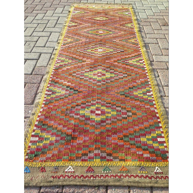 This beautiful, traditional vintage, hand knotted Turkish area runner rug is approximately 60 years old. It is handmade of...