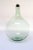 Pale green demijohn/carboy originally used for transporting wine (ca. Early 20th Century, France). Composed of 'blown-to-...