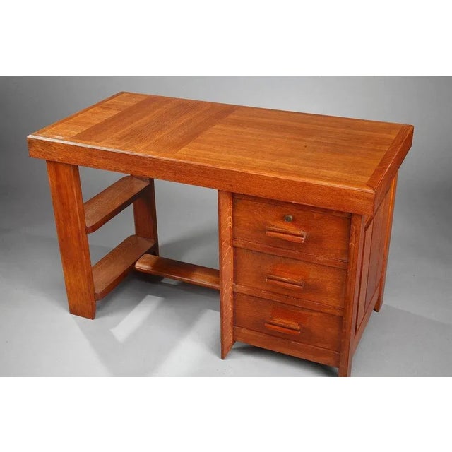 Charles dudouyt desk crafted in oak and veneer, with extendable leaf (l:50cm). This small desk has 3 drawers and 2 shelves...