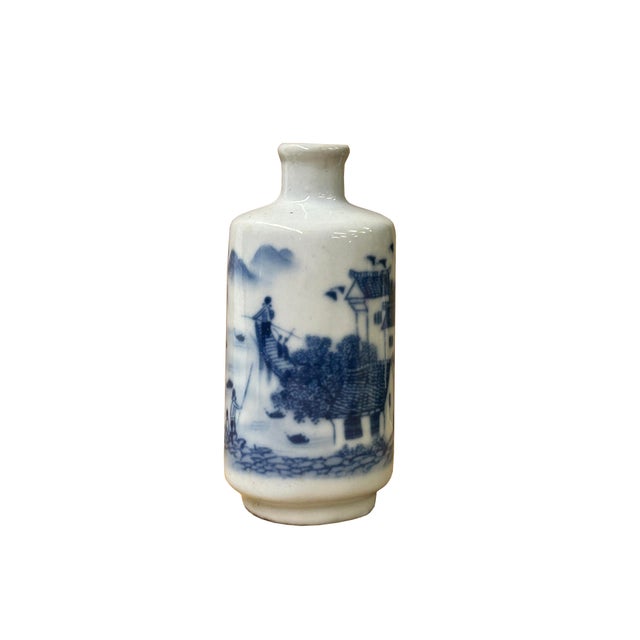 This charming 4.75" tall porcelain vase features delicate hand-painted blue and white scenery graphics depicting...