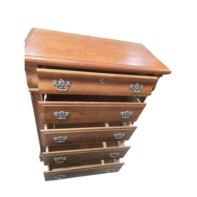 Classic vintage five-drawer highboy chest by Vaughan-Bassett, featuring a warm oak finish and beautifully pronounced wood...