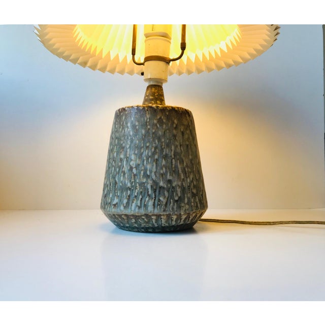 This stoneware table lamp was designed by Gunnar Nylund and produced by Rörstrand. It was made of hand-thrown stoneware in...