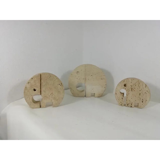 Trio of elephants of different measure. Travertine products from Mannelli brothers on Enzo Mari design. Good conditions as...
