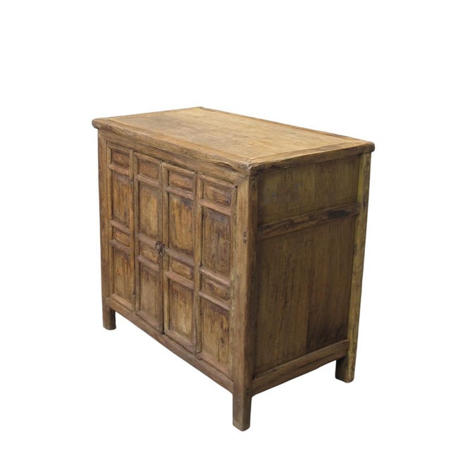 This well aged cabinet is constructed from solid elm wood, showcasing the deep grain and rugged texture of 4 century old...